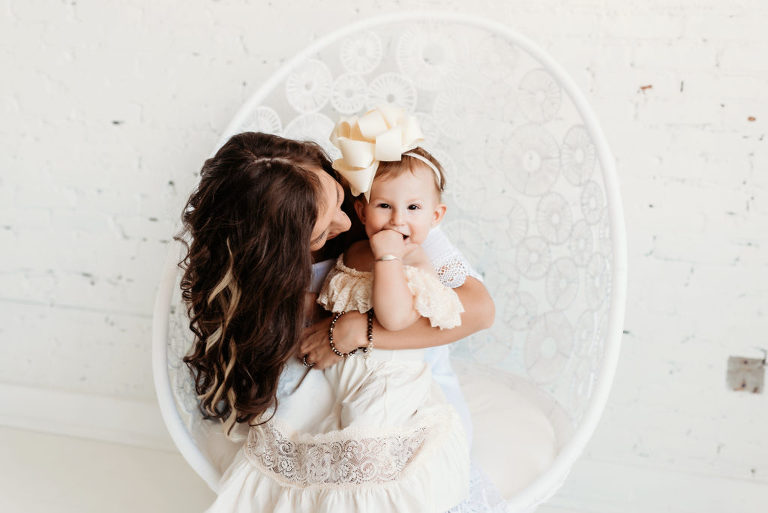 Mother and Daughter in white chair in new white studio